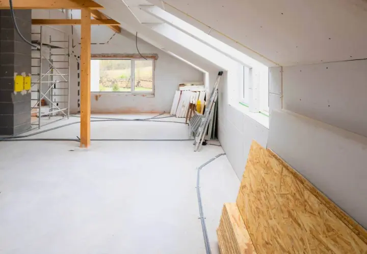 Budowa domu 30m2 w toku: rusztowania, materiały budowlane, instalacje.